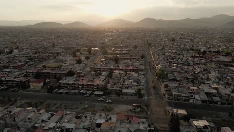 North-of-Mexico-city-at-golden-hour-sunset,-drone-aerial-boom-up-Establishing-shot