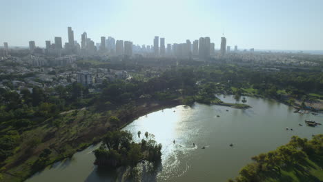 Flight-over-Tel-Aviv's-vast-Yarkon-Park-includes-extensive-lawns,-sports-facilities,-botanical-gardens,-a-water-park-and-a-lake-with-pedal-boats-for-visitors-who-arrive-every-day