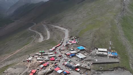 Aerial-View-Over-Mountain-Top-Shops-And-Huts-To-Reveal-Winding-Road-At-Babusar-Pass