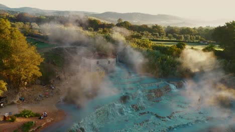 Cascate-del-Mulino,-Soothing-Natural-Hot-Springs-Bath,-Saturnia,-Tuscany,-Italy,-Europe,-Drone-view-traveling-up