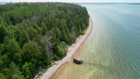 Aerial-view-of-sandy-forested-coastline,-Lake-Huron,-Michigan