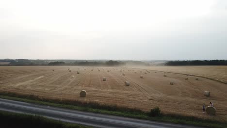 A-cinematic-4K-drone-shot-of-fields-with-hay-bales-and-an-epic-atmosphere-with-fog