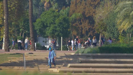 Grandfather-and-granddaughter-walk-together-at-Yarkon-Park-,-the-park-is-in-the-center-of-Tel-Aviv-and-it-has-playgrounds-for-children