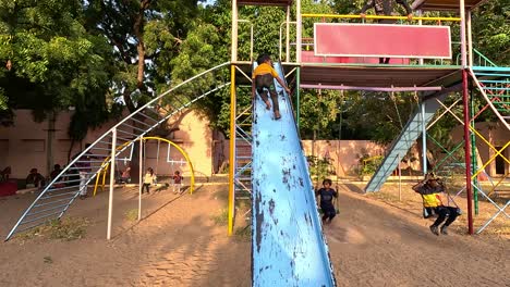A-young-child-shows-off-his-talent-by-riding-on-the-front-of-a-sliding-ride