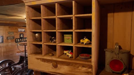 antique-toy-cars-and-other-objects-on-the-shelves-inside-of-an-old-wooden-barn