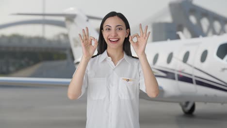 Happy-Indian-woman-pilot-showing-okay-sign