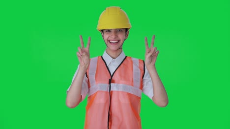 Happy-Indian-female-architect-showing-victory-sign-Green-screen