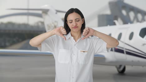 Disappointed-Indian-woman-pilot-showing-thumbs-down