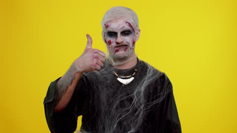 Sinister-man-Halloween-zombie-raises-thumbs-up-agrees-with-something-or-gives-positive-reply,-likes