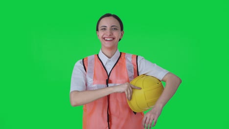 Happy-Indian-female-architect-removing-hat-after-work-Green-screen