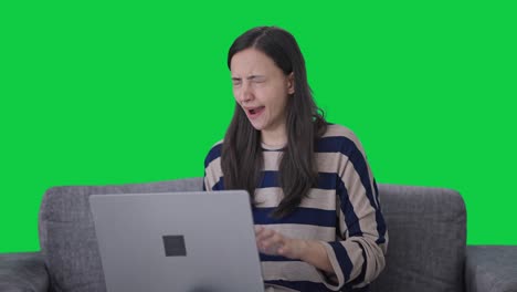 Tired-Indian-girl-using-laptop-Green-screen