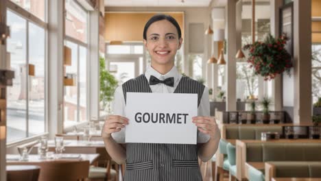 Happy-Indian-woman-waiter-holding-GOURMET-banner