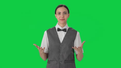 Happy-Indian-woman-waiter-talking-to-the-customer-Green-screen