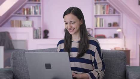 Happy-Indian-girl-using-laptop