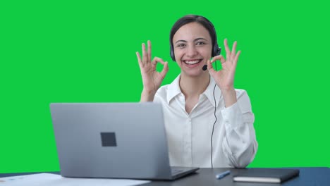 Happy-Indian-call-center-girl-showing-okay-sign-Green-screen