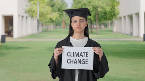 Sad-Indian-college-graduate-girl-holding-CLIMATE-CHANGE-banner