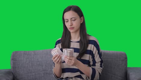 Serious-Indian-girl-counting-money-Green-screen