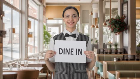 Happy-Indian-woman-waiter-holding-DINE-IN-banner