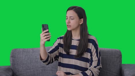 Indian-girl-talking-on-video-call-Green-screen