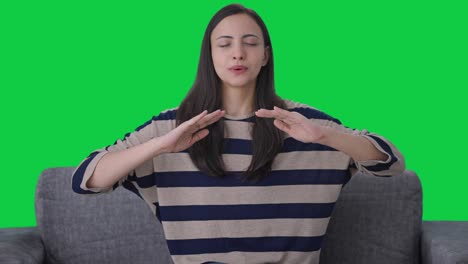 Happy-Indian-girl-doing-breathe-in-breathe-out-exercise-Green-screen