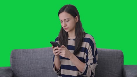 Serious-Indian-girl-chatting-with-someone-Green-screen