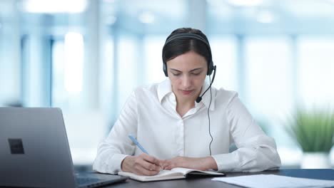 Indian-call-center-girl-talking-to-customer-and-taking-notes