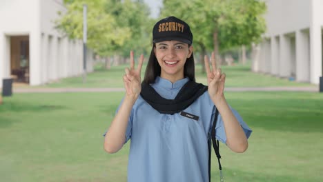 Happy-Indian-female-security-guard-showing-victory-sign
