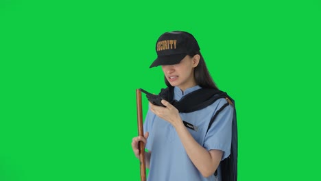 Angry-Indian-female-security-guard-shouting-through-walkie-talkie-Green-screen