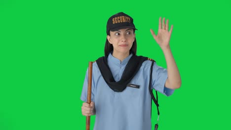 Happy-Indian-female-security-guard-giving-directions-to-someone-Green-screen