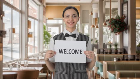Happy-Indian-woman-waiter-holding-WELCOME-banner