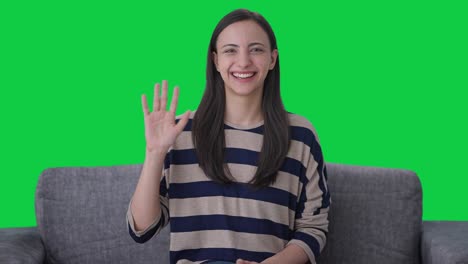 Happy-Indian-girl-waving-Hi-to-the-camera-Green-screen
