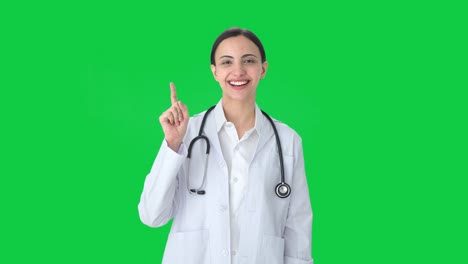 Happy-Indian-female-doctor-talking-to-the-camera-Green-screen