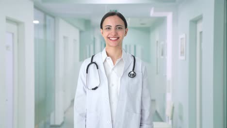 Happy-Indian-female-doctor-putting-stethoscope-on-shoulders