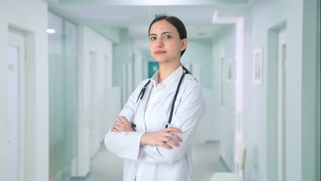 Portrait-of-Indian-female-doctor-standing-crossed-hands