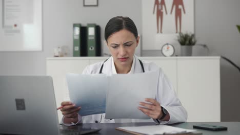 Stressed-Indian-female-doctor-explaining-medical-report-to-patient