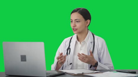 Happy-Indian-female-doctor-consulting-patient-on-video-call-Green-screen
