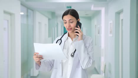 Happy-Indian-female-doctor-explaining-medical-reports-to-patient-on-call