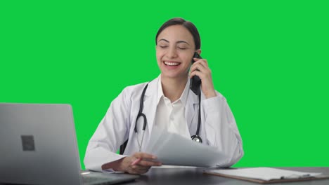 Happy-Indian-female-doctor-explaining-report-to-patient-on-call-Green-screen