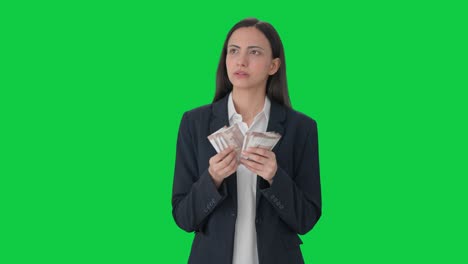 Confused-Indian-business-woman-counting-money-Green-screen