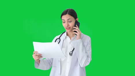 Happy-Indian-female-doctor-explaining-medical-reports-to-patient-Green-screen