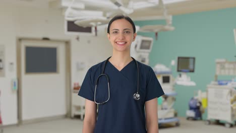 Happy-Indian-female-doctor-in-scrub-suit-smiling