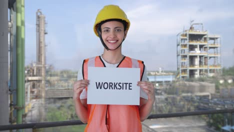 Happy-Indian-female-construction-worker-holding-WORKSITE-banner