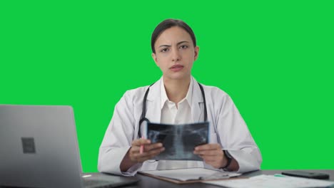 Indian-female-doctor-explaining-X-ray-report-to-patient-Green-screen