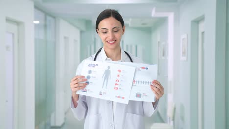 Happy-Indian-female-doctor-explaining-medical-reports-to-patient