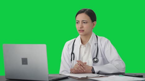Sad-Indian-female-doctor-consulting-patient-on-video-call-Green-screen