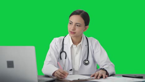 Happy-Indian-female-doctor-studying-for-exams-Green-screen