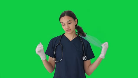 Tensed-Indian-doctor-removing-surgical-cap-after-fail-operation-Green-screen