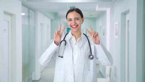 Happy-Indian-female-doctor-showing-victory-sign