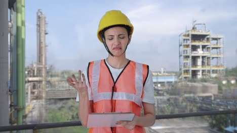Confused-Indian-female-construction-worker-taking-notes-of-building