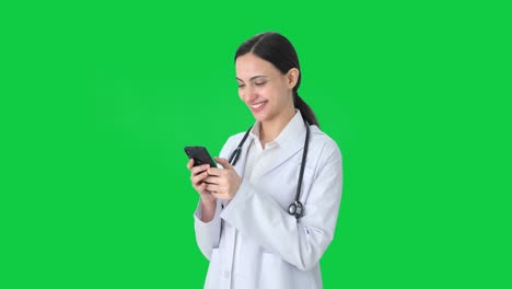 Happy-Indian-female-doctor-chatting-with-someone-Green-screen
